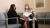 Doctor meets with patient and they are reviewing a written document